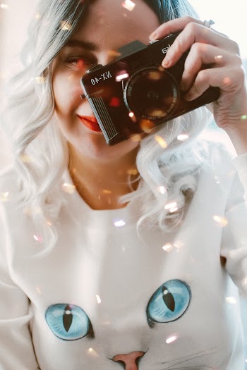 Woman Holding Camera Close-up Photo