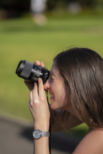Woman Holding Camera in Bokeh Photography