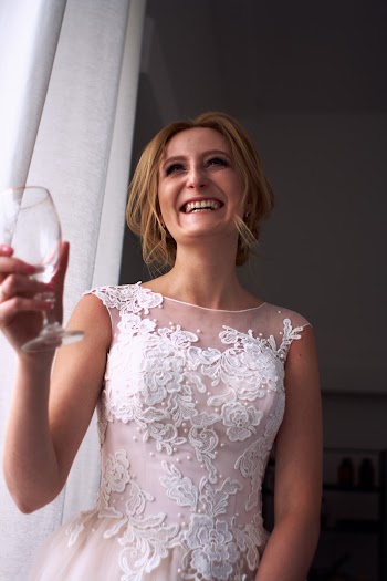 Woman Holding Clear Glass Footed Cup