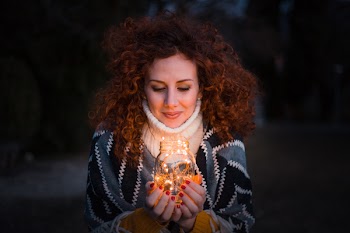 Woman Holding Clear Glass Jar Filled With Lights
