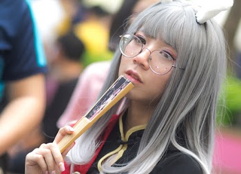Woman Holding Closed Handfan