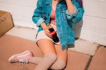 woman holding Coca-Cola bottle