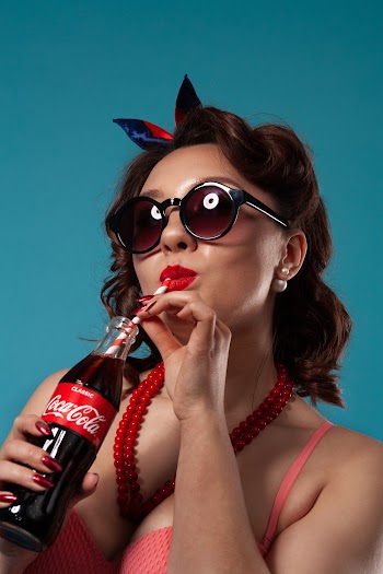 Woman Holding Coca Cola Glass Bottle