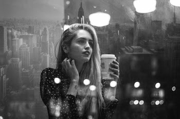 woman holding coffee up
