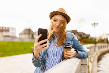 Woman Holding Cup While Taking Selfie