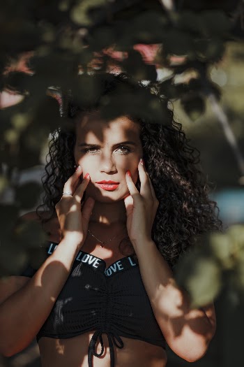 Woman Holding Face Under Tree