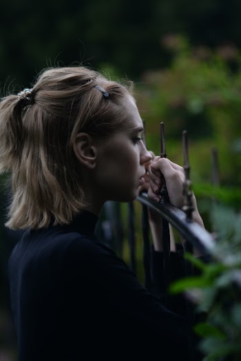 Woman Holding Fence