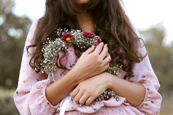 woman holding floral headband