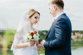 Woman Holding Flower Bouquet Standing in Front of Man