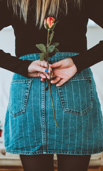 Woman Holding Flower On Her Back