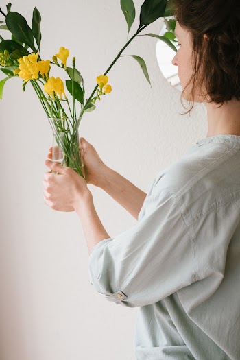 Woman Holding Flower Vase