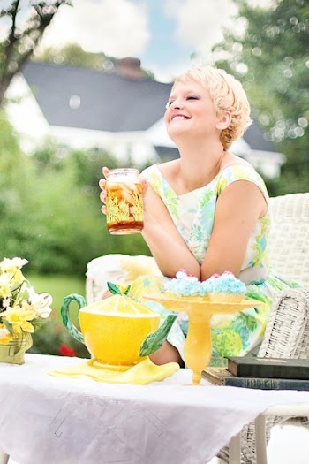 Woman Holding Glass Jar on Wicker Sofa