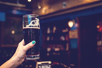 Woman Holding Glass of Beer