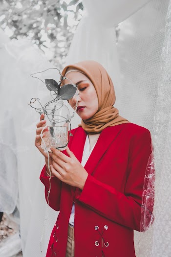 Woman Holding Glass With Plant