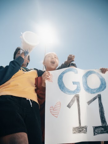 Woman Holding Go 11 Banner