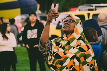 Woman Holding Gold Smartphone