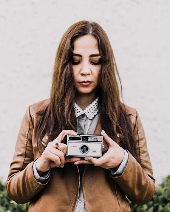 Woman Holding Gray Camera on Focus Photography