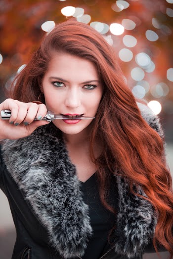 Woman Holding Gray Handled Knife