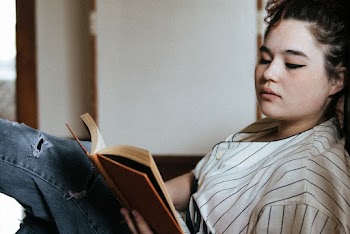 Woman Holding Hardbound Book