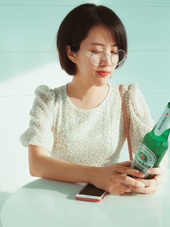 Woman Holding Heineken Bottle