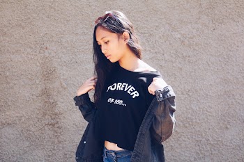 Woman Holding Her Black Denim Jacket Looking Down
