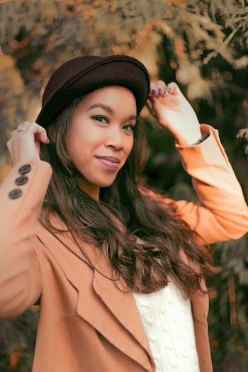 Woman Holding Her Black Hat