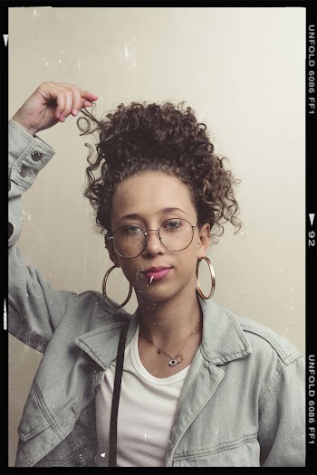 Woman Holding Her Curly Hair Screenshot