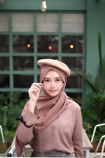 Woman Holding Her Eyeglasses