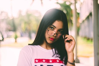 Woman Holding Her Eyeglasses