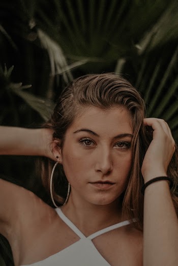 Woman Holding Her Hair Beside Tree