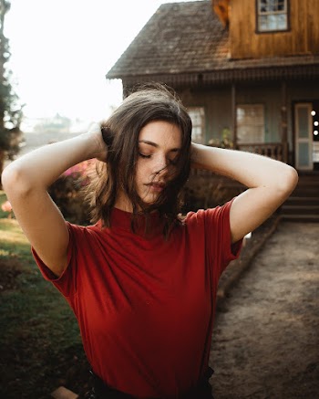 Woman Holding Her Hair While Closing Her Both Eyes