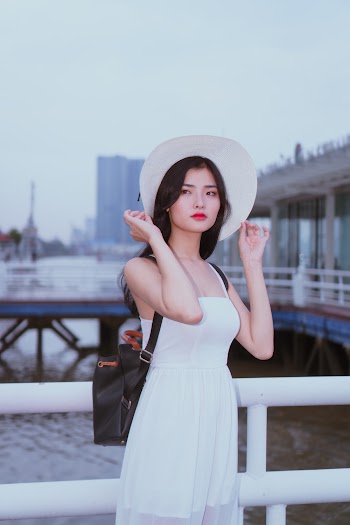 Woman Holding Her Hat