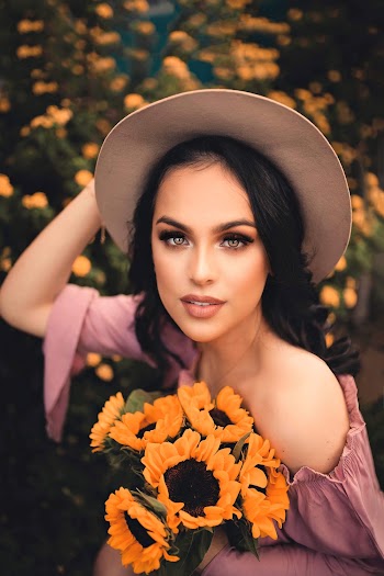Woman Holding Her Hat