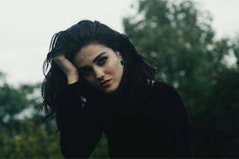 woman holding her head with her right hand