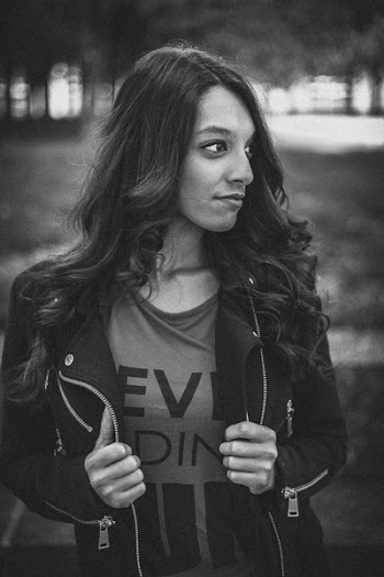 Woman Holding Her Jacket While Looking Sideway