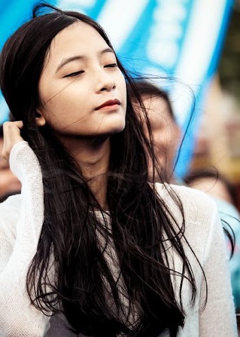woman holding her long black hair