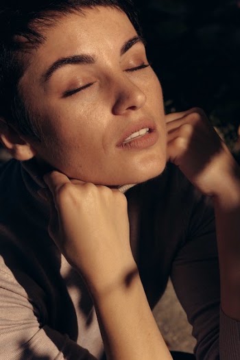 Woman Holding Her Shirt's Collar