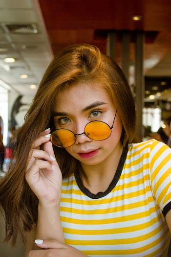 Woman Holding Her Sunglasses