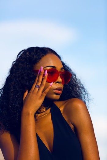 woman holding her sunglasses