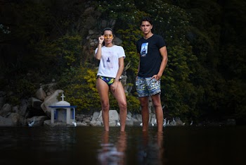 Woman Holding Her Sunglasses Beside Man