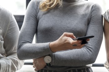 Woman Holding Her Waist and Touching Her Phone
