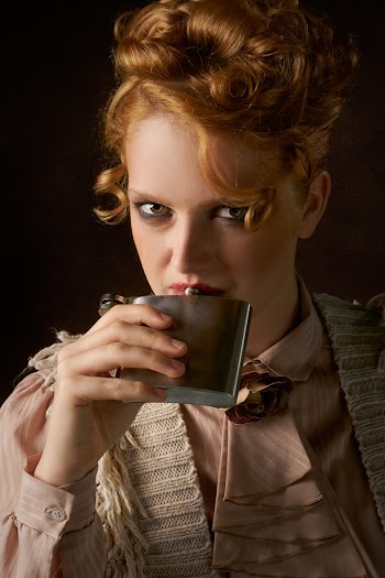 Woman Holding Hip Flask to Her Mouth