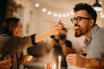 Woman Holding Ladle Beside Man