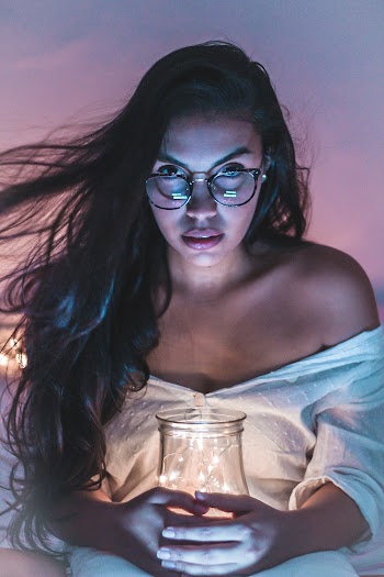 Woman Holding Lamp Wearing White Dress