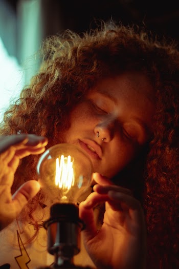 Woman Holding Light Bulb