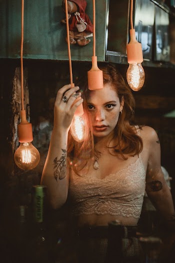 Woman Holding Lighted Pendant Lamp