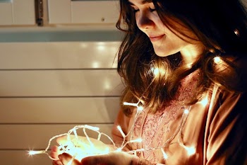 Woman Holding Lighted String Light