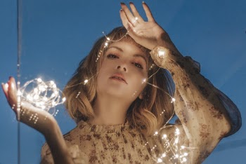 Woman Holding Lighted White String Lights