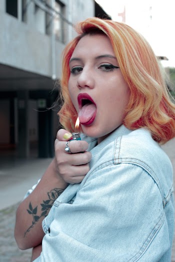 Woman Holding Lighter and Opening Mouth