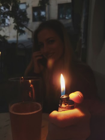Woman Holding Lit Lighter